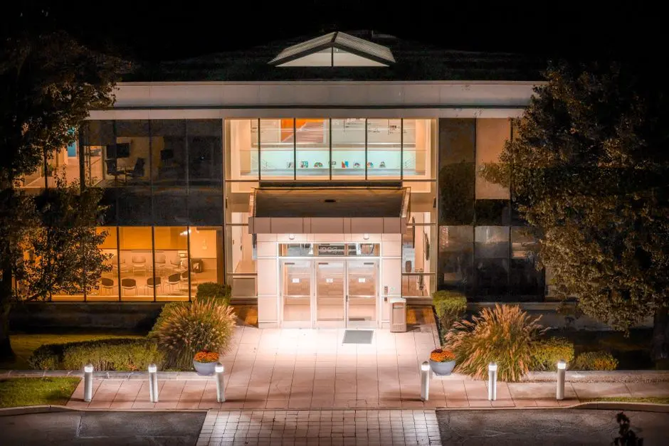 Professional security patrol building at night